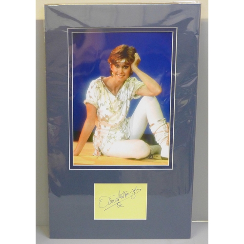 768 - An Olivia Newton-John autographed display, (no COA)