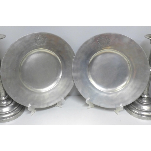 786 - A collection of pewter including a pair of large candlesticks, a shallow bowl and a pair of plates