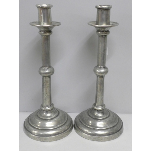 786 - A collection of pewter including a pair of large candlesticks, a shallow bowl and a pair of plates