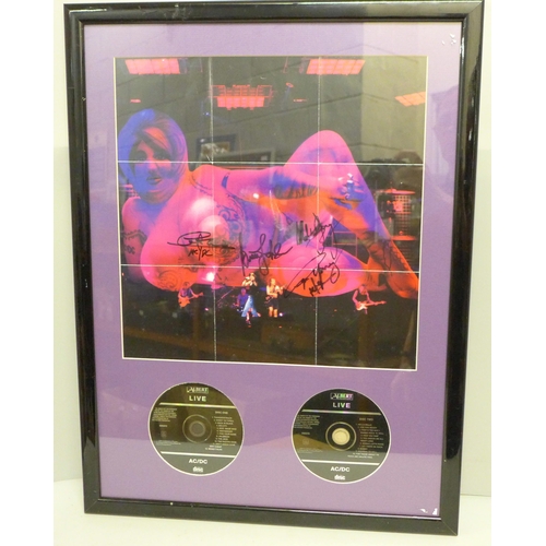 790 - An AC/DC autographed CD poster display, (no COA)