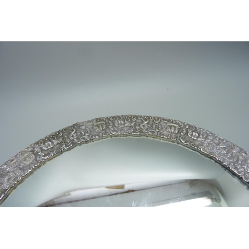 839 - An Eastern white metal mirrored tray, tests as silver, one foot missing, 27cm