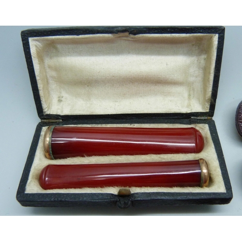 870 - Two amber cheroot holders, smallest with 9ct gold rims, and a set of two sherry amber cheroot holder... 