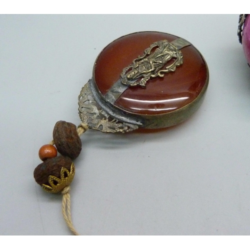 876 - A Chinese agate set pendant and a dog of foe mounted on a ball