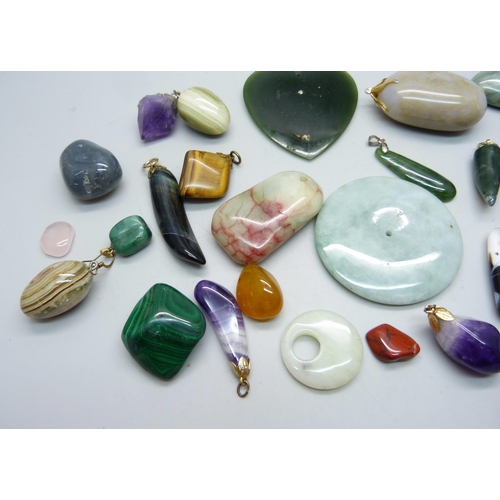 893 - A collection of hardstone pendants and unmounted stones