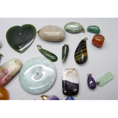 893 - A collection of hardstone pendants and unmounted stones