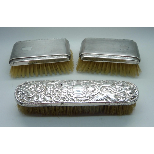 906 - Three silver backed brushes