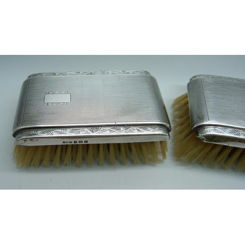 906 - Three silver backed brushes