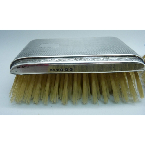 906 - Three silver backed brushes