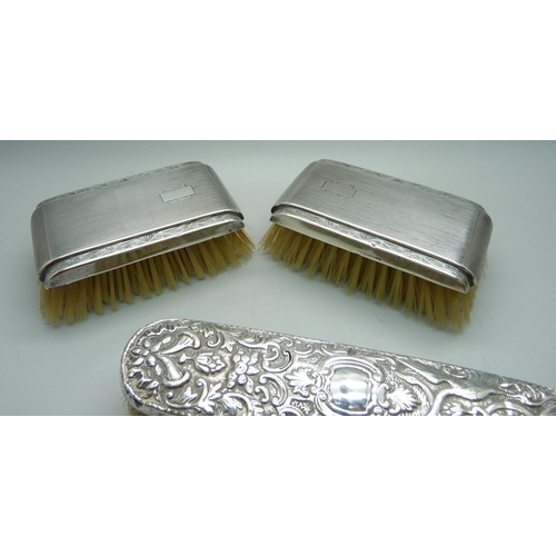 906 - Three silver backed brushes