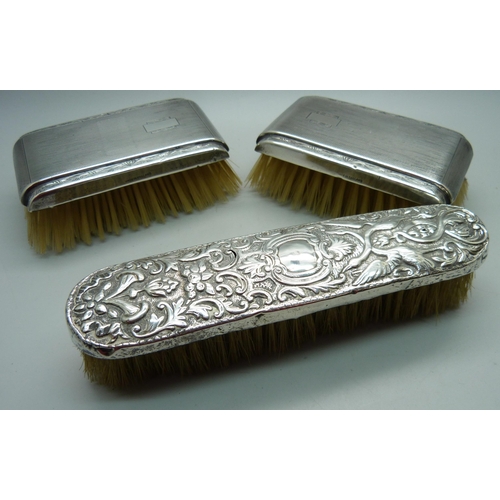 906 - Three silver backed brushes