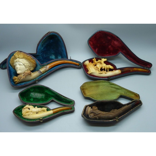 909 - Four Meerschaum pipes with amber stems, cased, one a/f