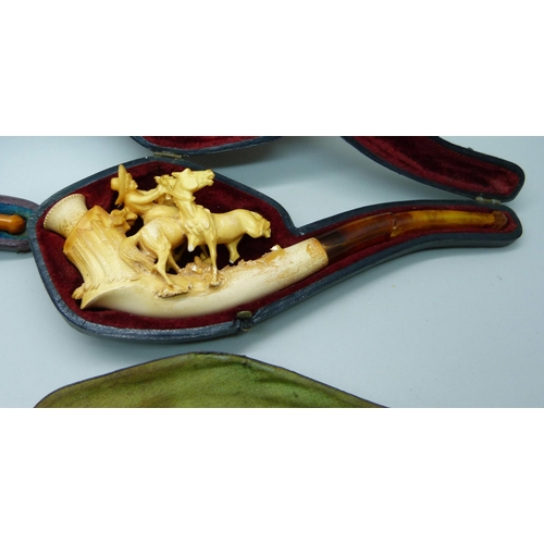 909 - Four Meerschaum pipes with amber stems, cased, one a/f