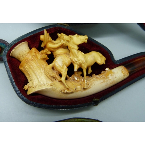 909 - Four Meerschaum pipes with amber stems, cased, one a/f