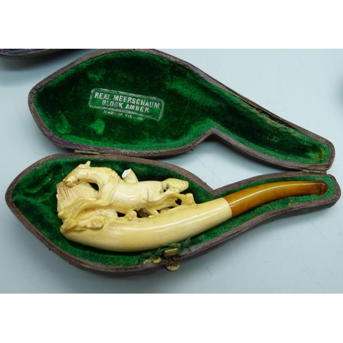 Four Meerschaum pipes with amber stems, cased, one a/f