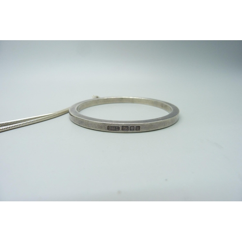 940 - A hallmarked silver bangle, 47g, 62mm, and a silver pendant and chain