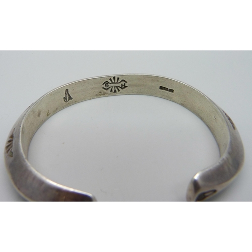 941 - A sterling silver Navajo bangle, maker GH, 47.6g