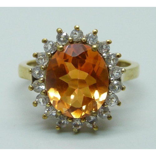 951 - A silver gilt Padparadscha topaz and zircon halo ring, R/S