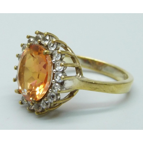 951 - A silver gilt Padparadscha topaz and zircon halo ring, R/S