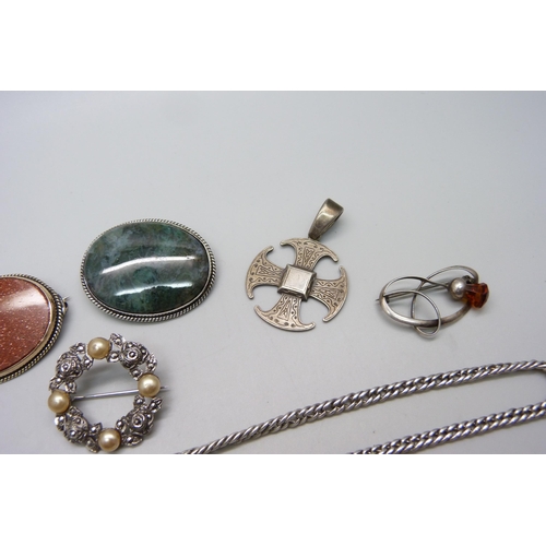 956 - A silver ring, a silver pendant, two stone set brooches, two silver brooches and a chain, (green sto... 