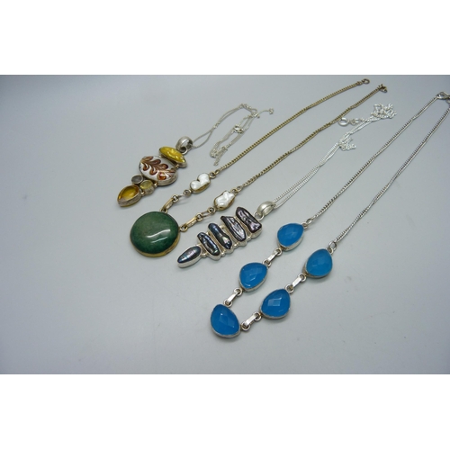 982 - Two silver pendants and chains, a white metal necklace and one other necklace