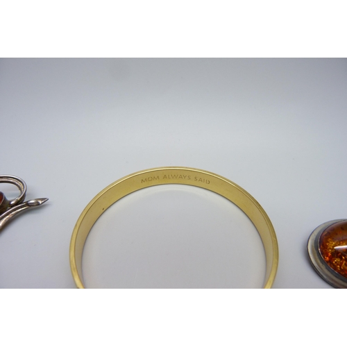 986 - Three amber set brooches, a jet brooch and a bangle