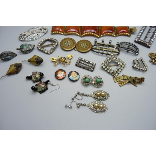 998 - A collection of vintage jewellery and buckles, including a gold mining brooch, one panel of large br... 