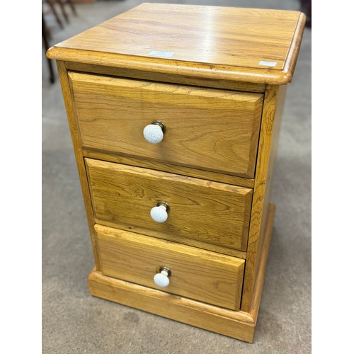 324 - A light oak three drawer chest of drawers