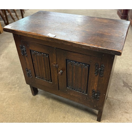 328 - A small carved oak linenfold cupboard