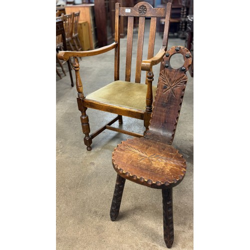 338 - A carved oak armchair and a pine milking stool