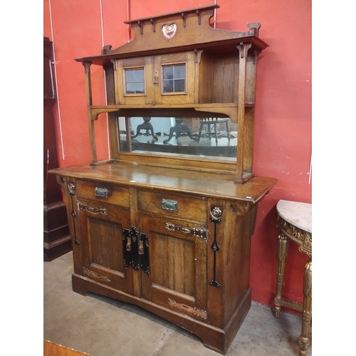 133 - An Arts and Crafts oak and copper mounted mirrorback sideboard