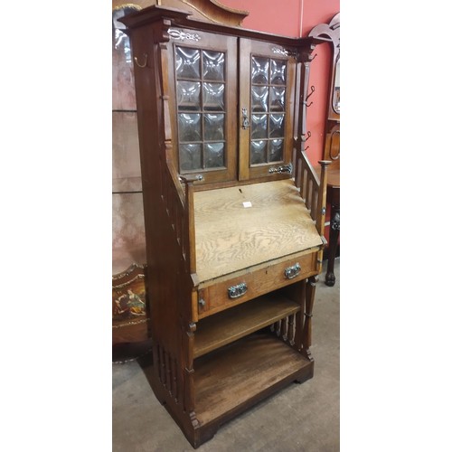 134 - An Arts and Crafts oak bureau bookcase