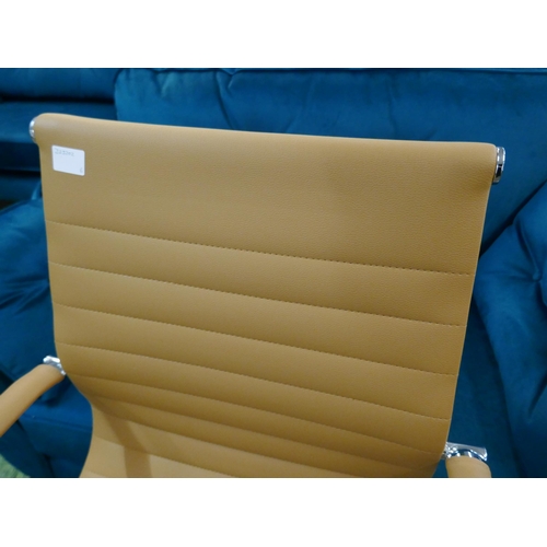 1323 - A tan Eames style office chair