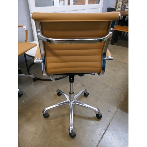 1324 - A tan Eames style office chair