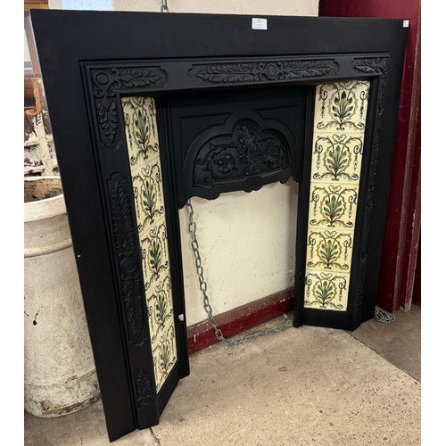 377 - A Victorian cast iron and tiled fire insert