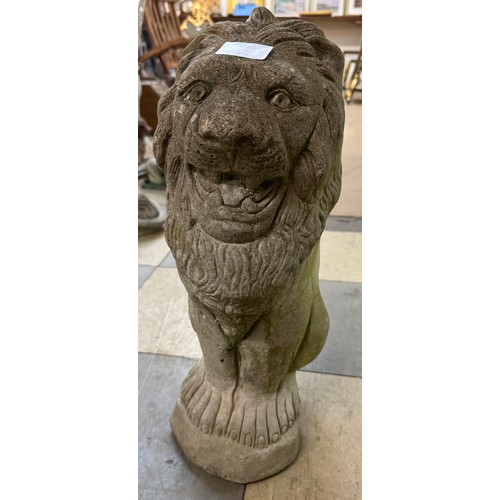 385 - A concrete garden figure of a seated lion