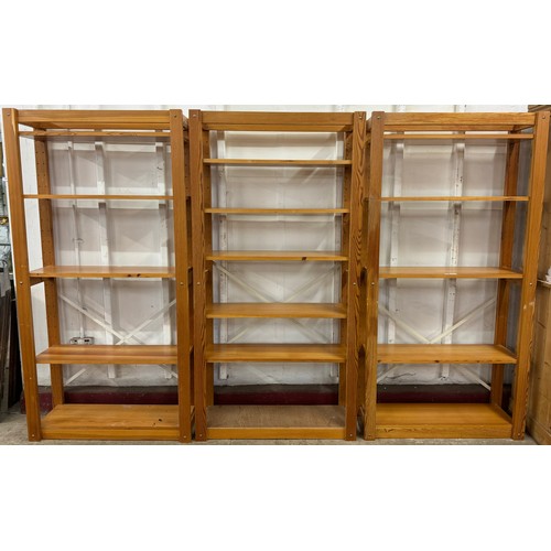 352 - A set of three pine freestanding wall racks