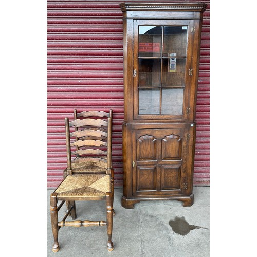 360 - A pair of elm and rush seated ladderback chairs and a mahogany corner cabinet