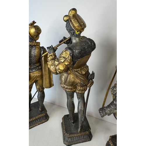 106 - A set of three 19th Century French gilt spelter figures of cavaliers and a musician, tallest; 25cms ... 