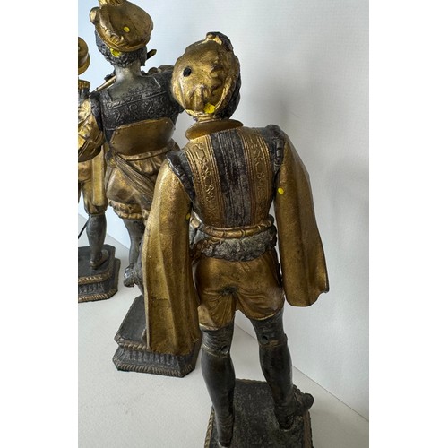 106 - A set of three 19th Century French gilt spelter figures of cavaliers and a musician, tallest; 25cms ... 