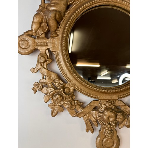 121 - A Victorian gilt metal framed mirror, cast with cherubs and inscribed; Welcome, Welcome, Thrice