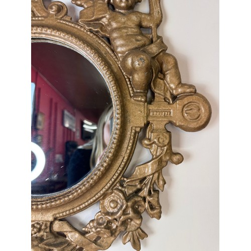 121 - A Victorian gilt metal framed mirror, cast with cherubs and inscribed; Welcome, Welcome, Thrice