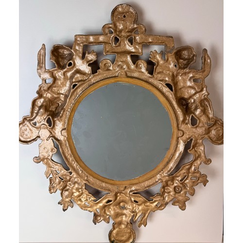 121 - A Victorian gilt metal framed mirror, cast with cherubs and inscribed; Welcome, Welcome, Thrice