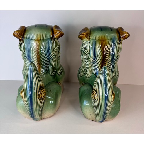 126 - A pair of Chinese green glazed porcelain Dogs of Foo