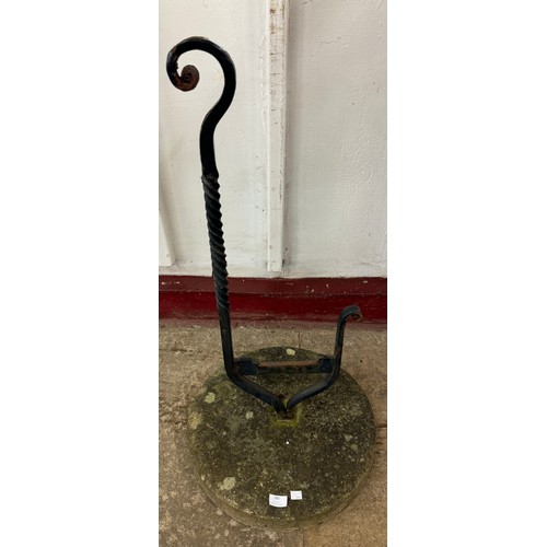 380 - A Victorian wrought iron boot scraper on stone base