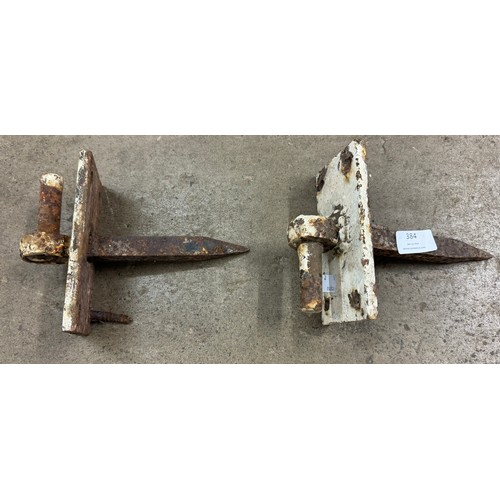 384 - A pair of cast iron gate hinges