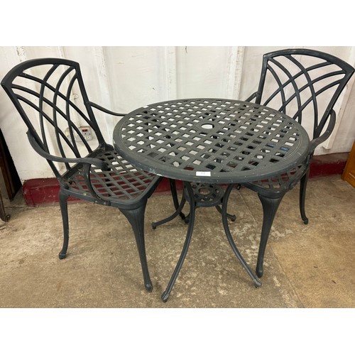 392 - A cast alloy garden table and two chairs