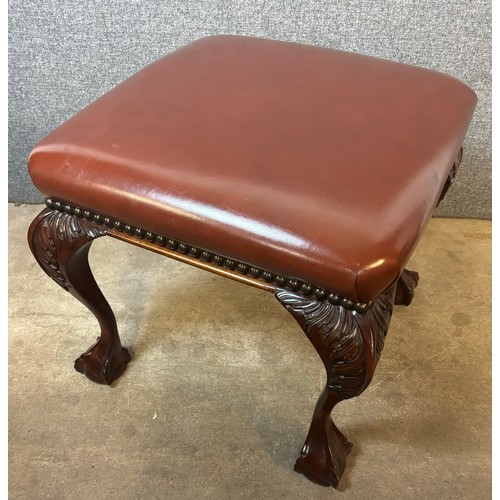 190 - A Chippendale revival carved mahogany and chestnut brown leather footstool