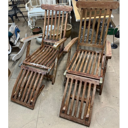 398 - A pair of reclining beech deckchairs