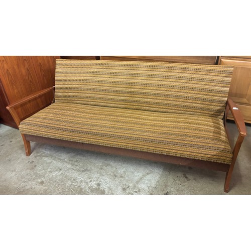 194 - A teak and fabric upholstered sofa bed