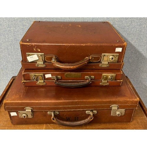 404 - Three leather suitcases